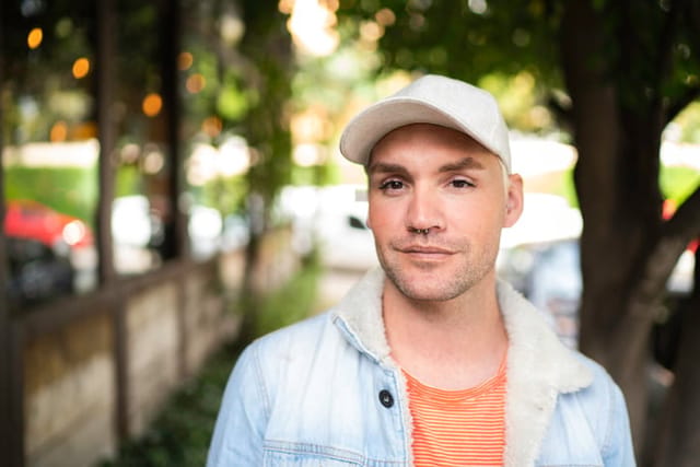 hipster guy in white hat walking down street