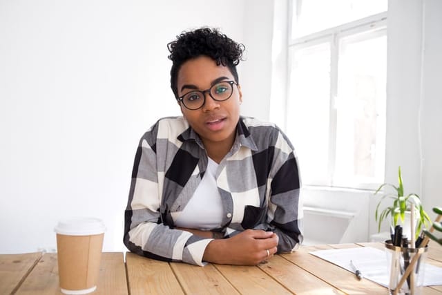 smiling woman sitting at desk