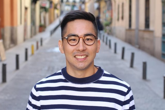smiling man with glasses in city