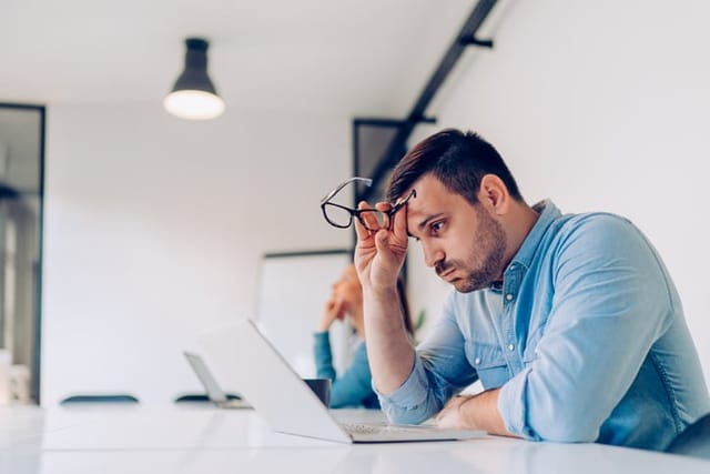 stressed out guy sitting at computer