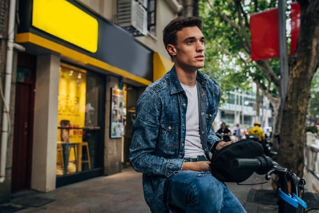 serious looking guy sitting outside