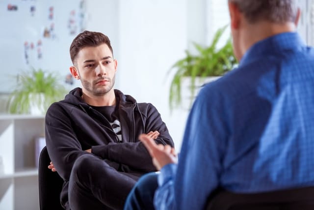guy with crossed arms listening