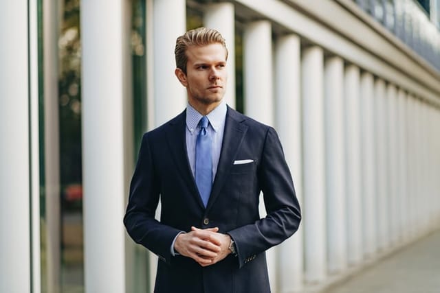 debonair man in business suit walking outside
