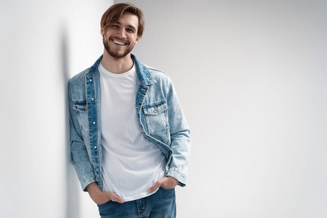 Fashion portrait of young man wearing jeans jacket.