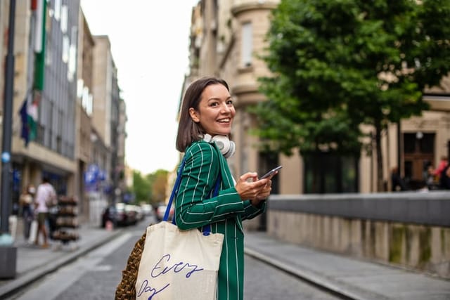 woman walking down street looking back