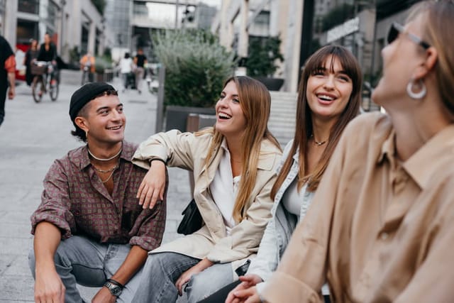 Happy group of young friends from generation Z meet up and having fun together in city downtown.