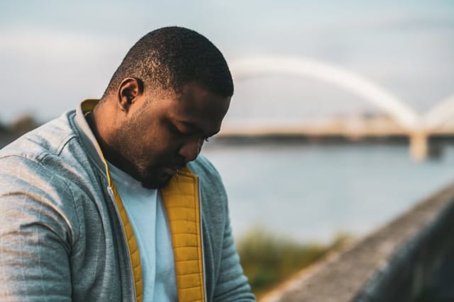 lonely man outdoors near bridge