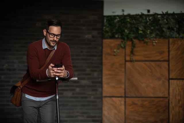 Young man using mobile phone outdoors.