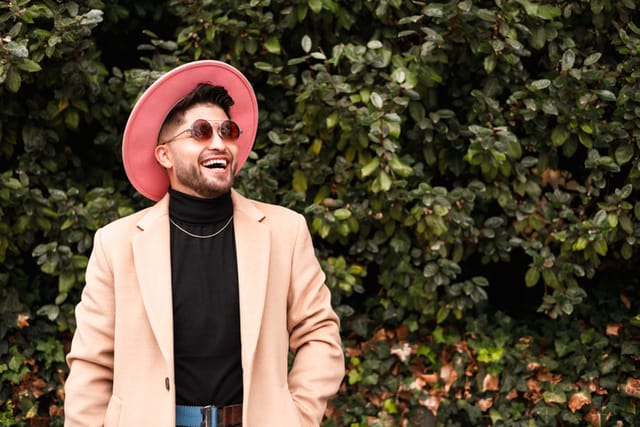 smiling man in hat looking up