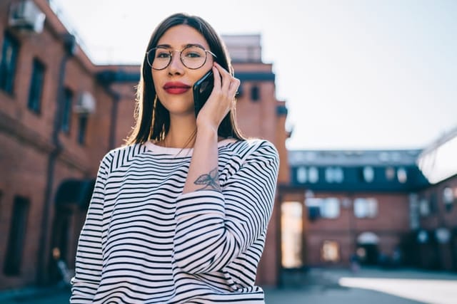 serious woman talking on phone outdoors