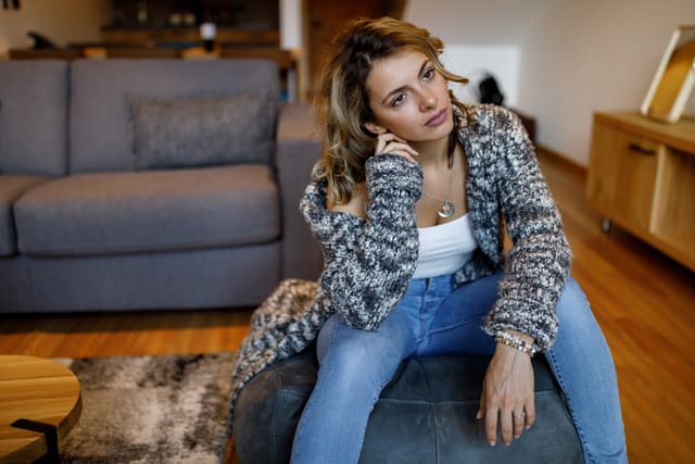 depressed woman sitting in her living room