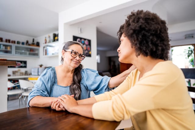 woman talking to her mom in kitchen