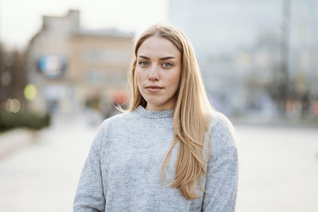 serious blonde woman outside