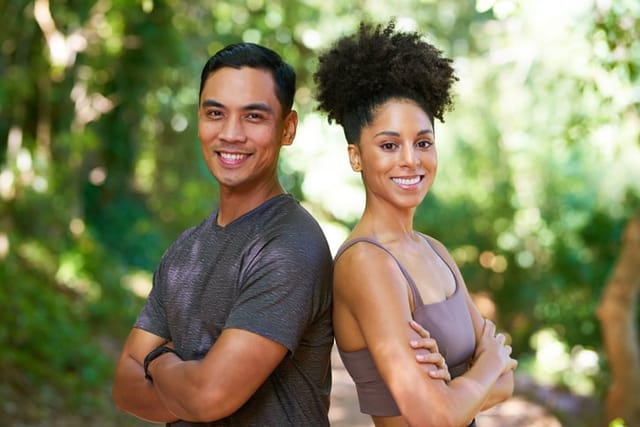 Two people standing back to back after a run.