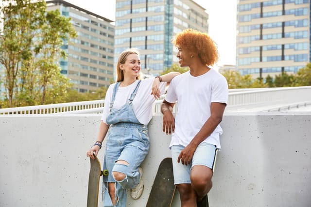 two friends chatting with skateboards