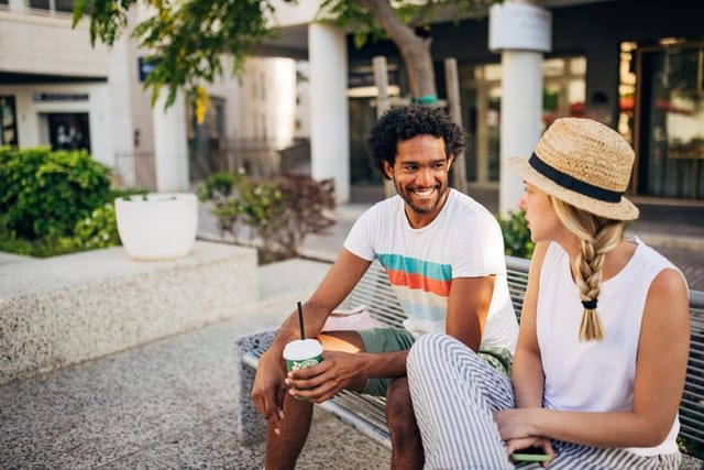 male and female friend chatting on sunny day