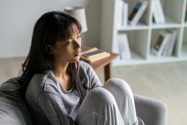 young woman feeling depressed at home