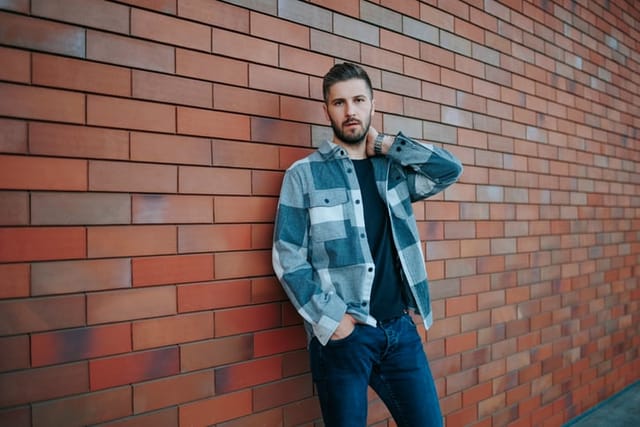 pessimistic guy against brick wall