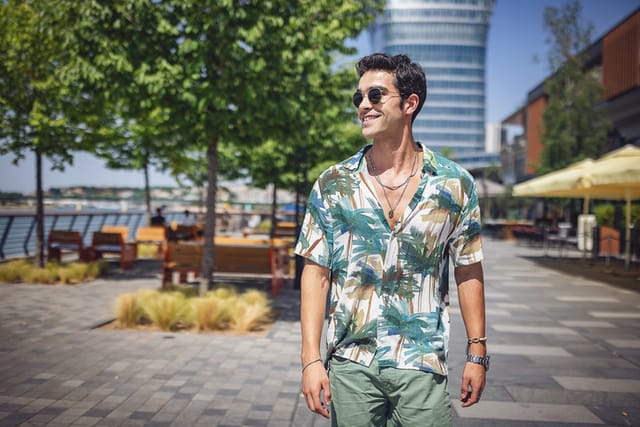 man on sunny day walking by water