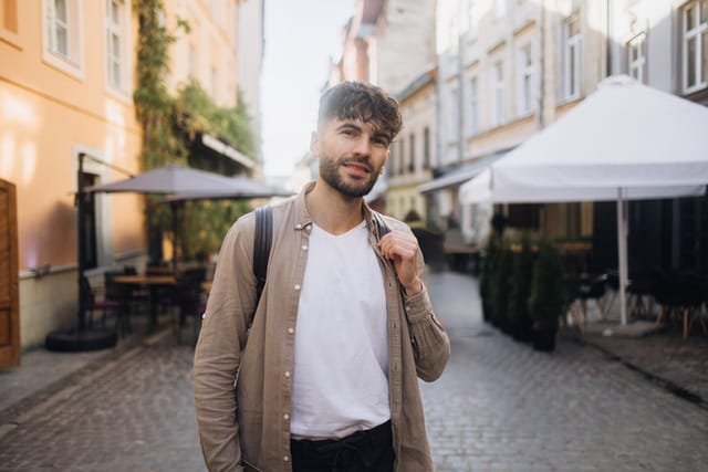 serious man in city center with backpack