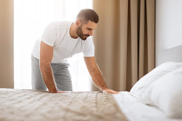 Man Making His Bed and Tidying His Bedroom.