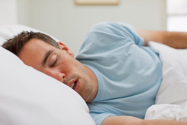 Man sleeping in bed.