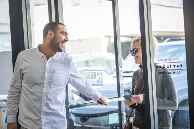 Store owner opens the door.