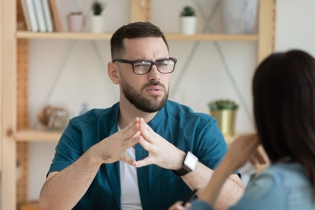 Businessperson speaking with his coworkers.