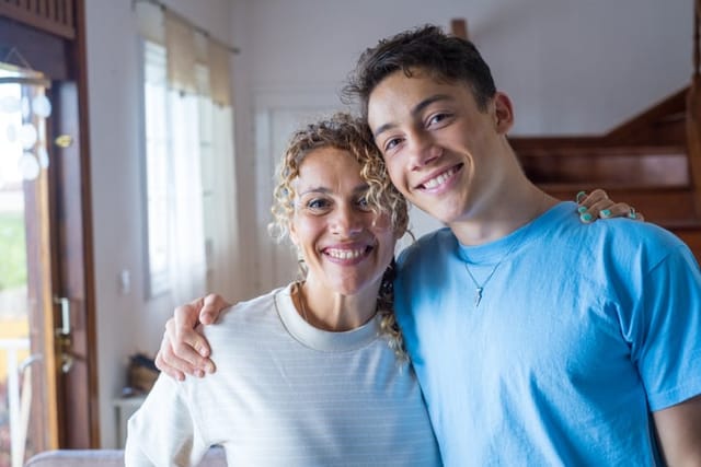 Teenager hugging middle-aged mother.