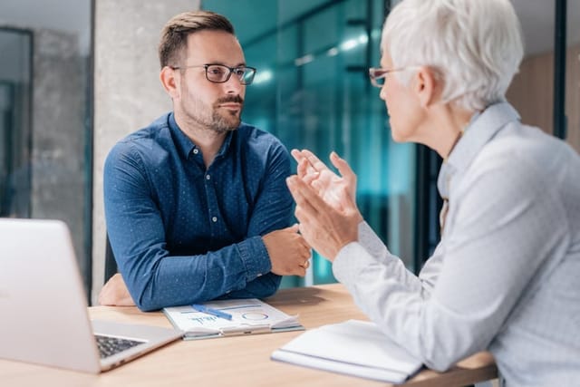 Two business people working together in office.