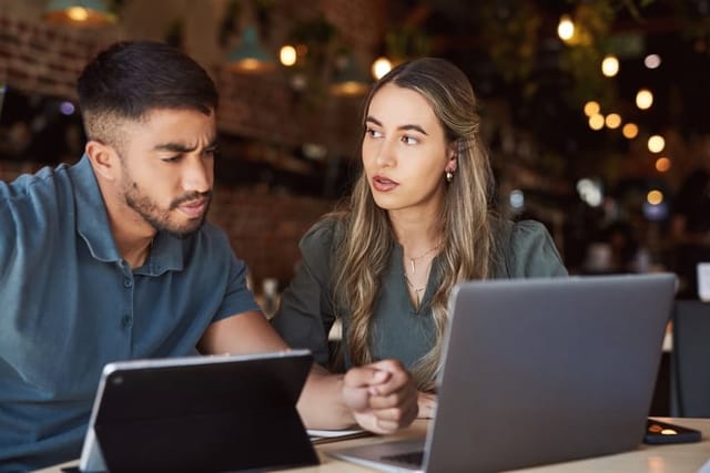 Man and woman collaborating on work.
