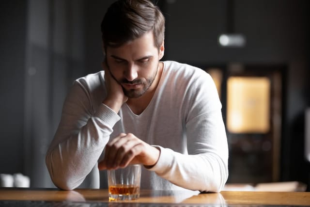 Man having a drink by himself.