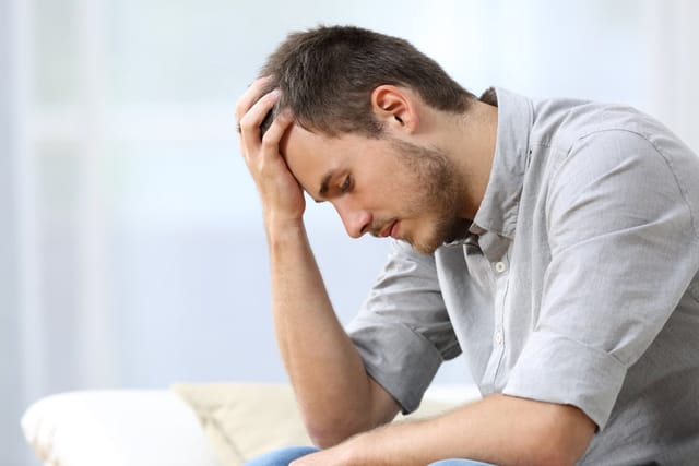 A sad man thinking
