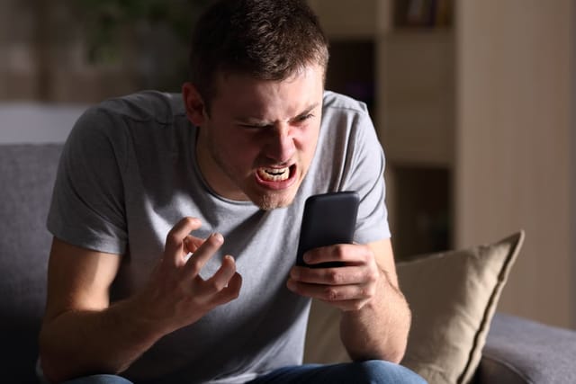 Angry man on the phone.