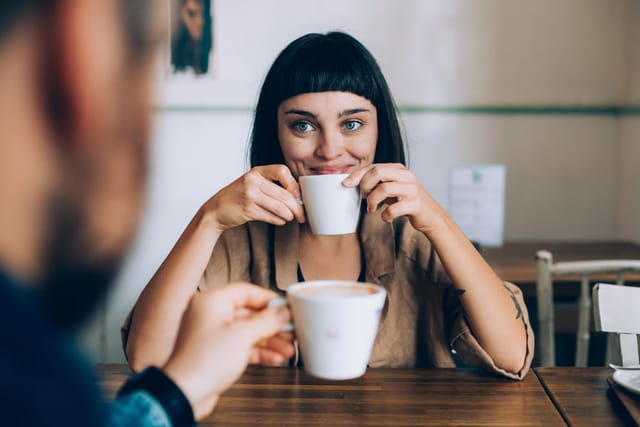 Woman drinking a cup of coffee.