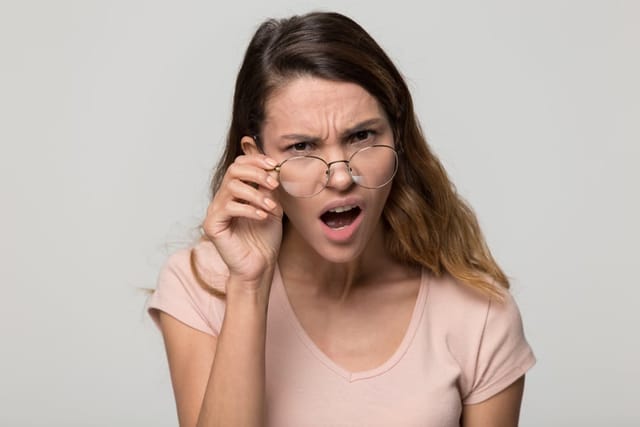 Shocked young woman looking angry.