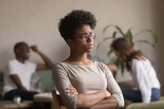 Woman sitting alone with her arms crosse.