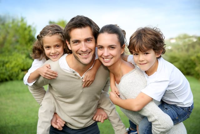 Parents giving piggyback rides.