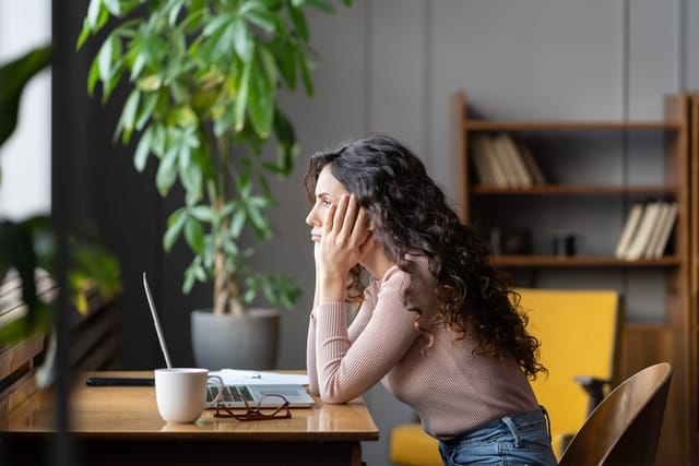 Young woman sitting at her desk.