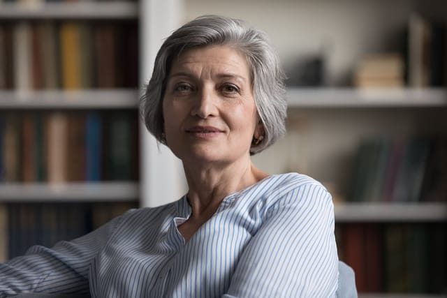 An older woman with a smug look on her face.