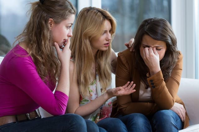 Young woman comforting a friend.