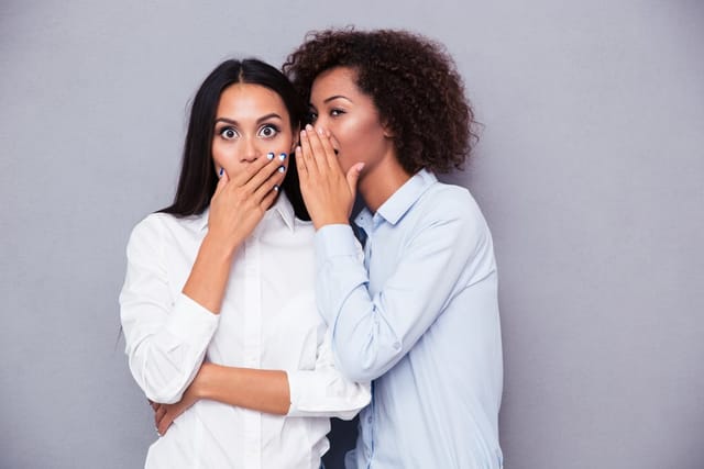 Two women gossiping.