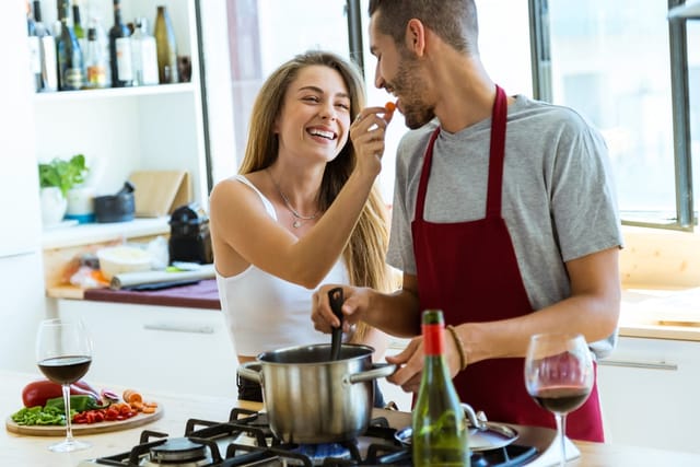 Young couple cooking at home.