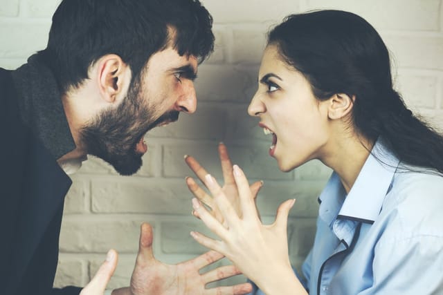 Young couple yelling at one another.