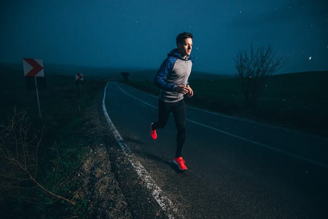 Man running outside at night.