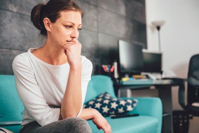Unhappy woman thinking over things.