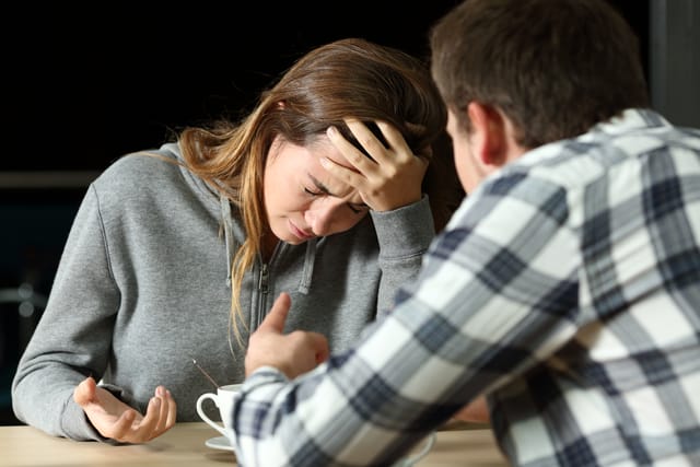 Sad woman having an argument with a man.