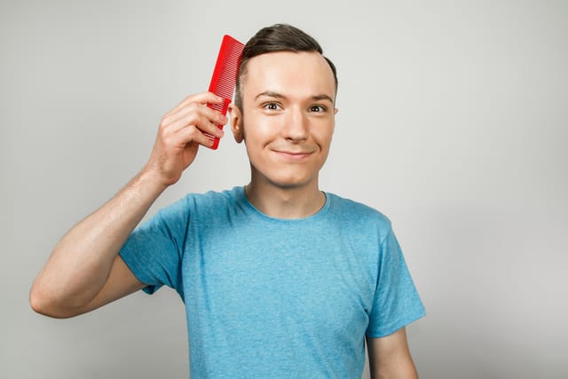 Man combing his hair.