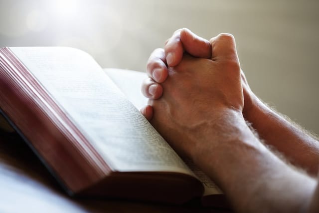 Hands folded in prayer.