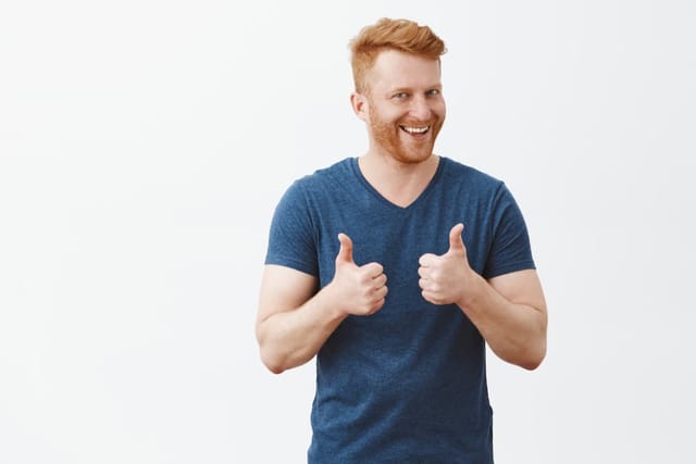 Happy man holding two thumbs up.